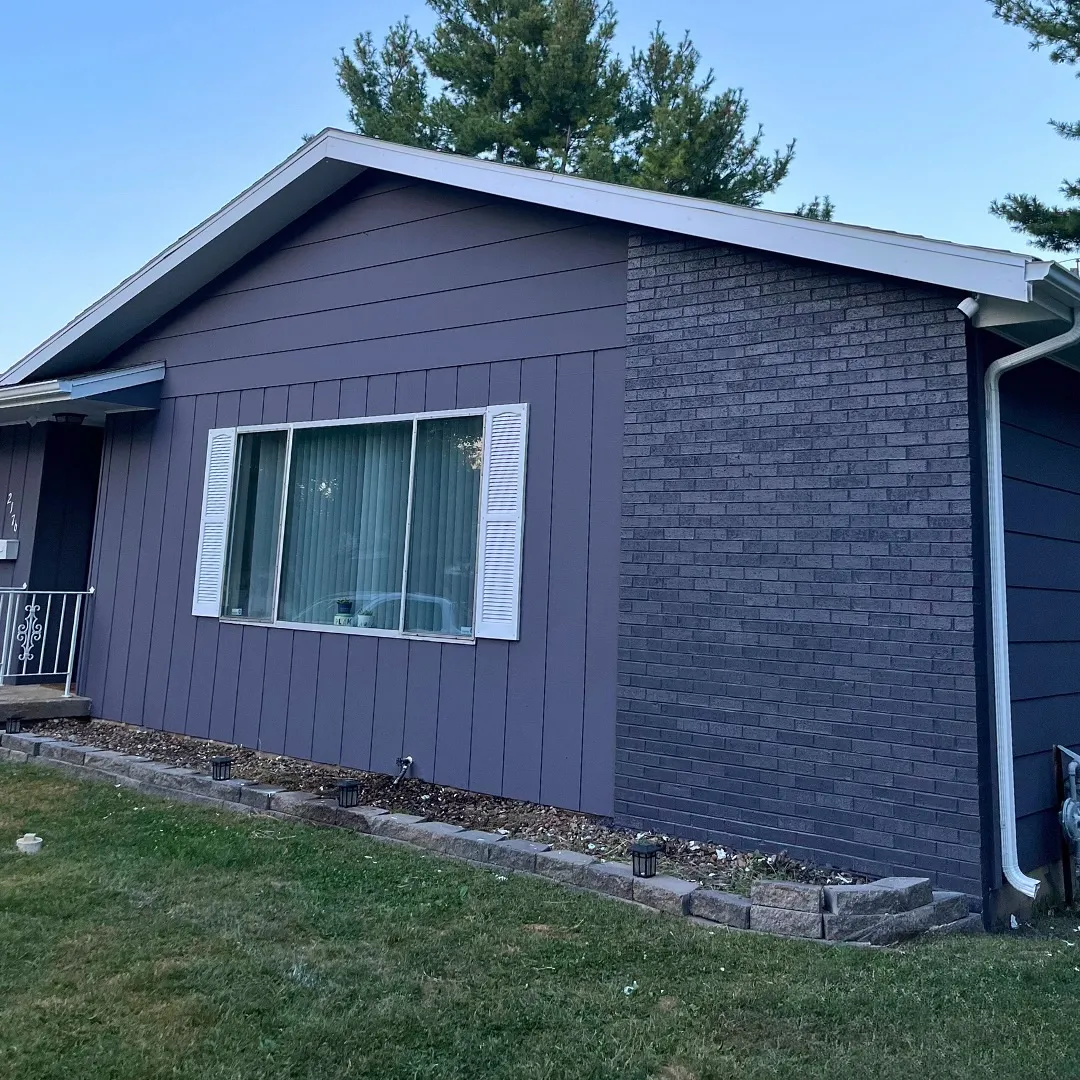 Professional exterior house painting with blue siding in Decatur IL